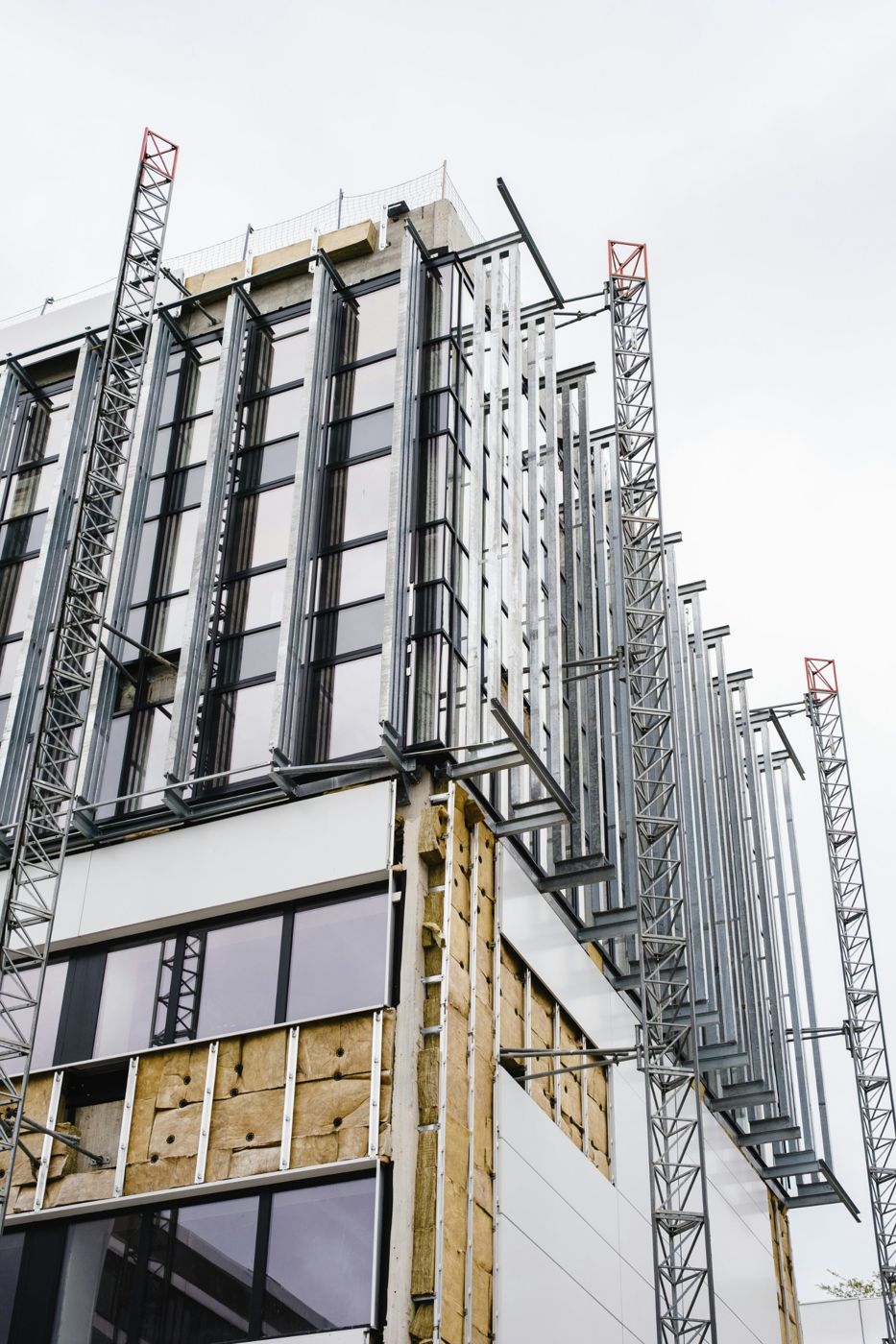 Building façade with steel framing, insulation and glazing in progress